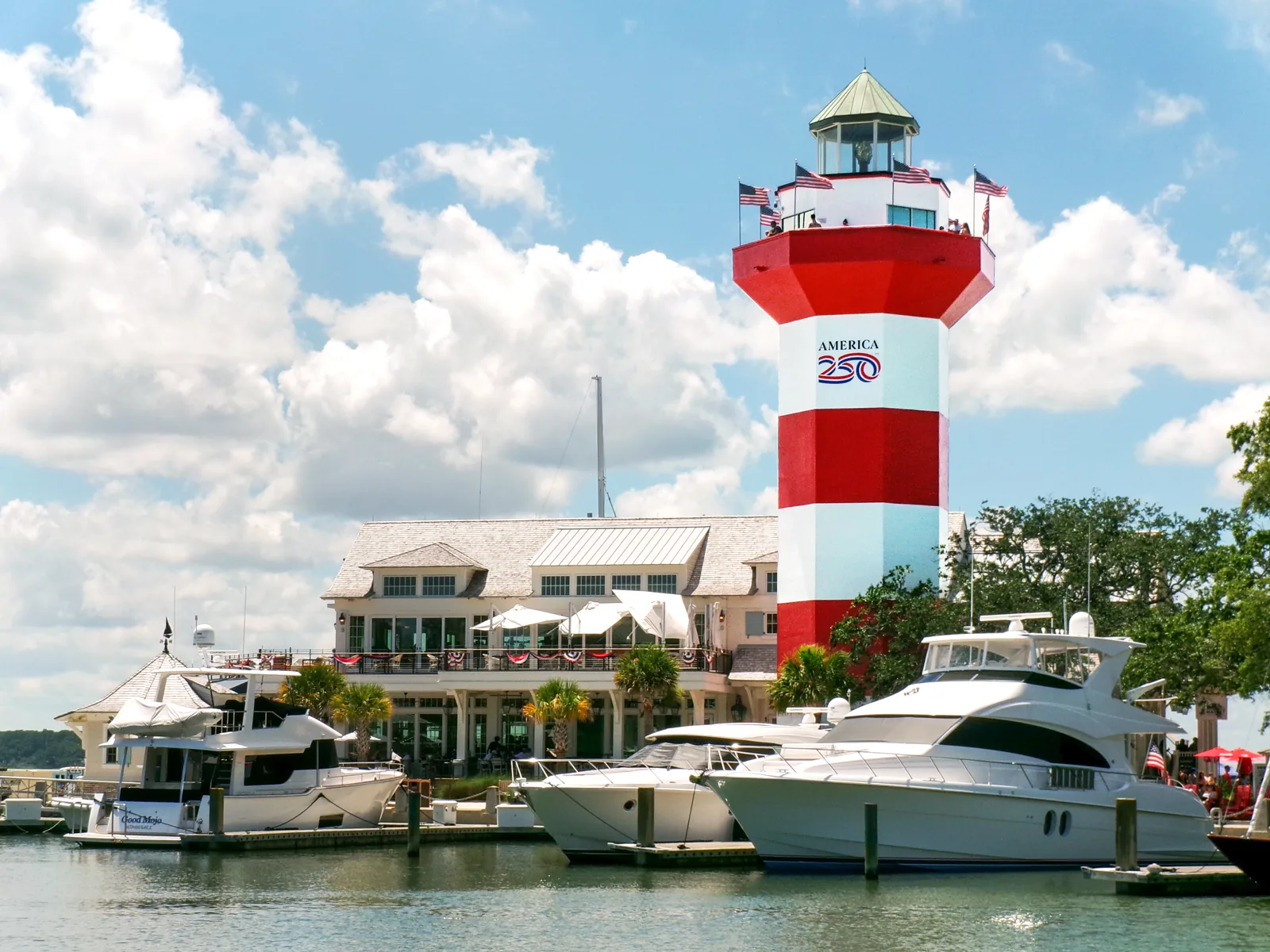 Red-and-white Harbour Town lighthouse beside boats in Sea Pines marina